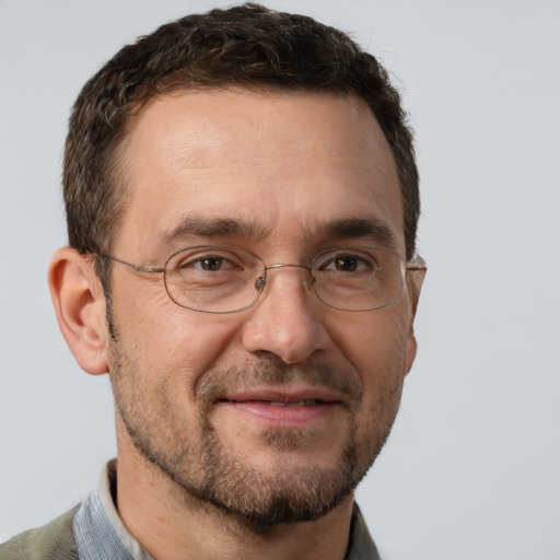 Joyful white adult male with short  brown hair and brown eyes