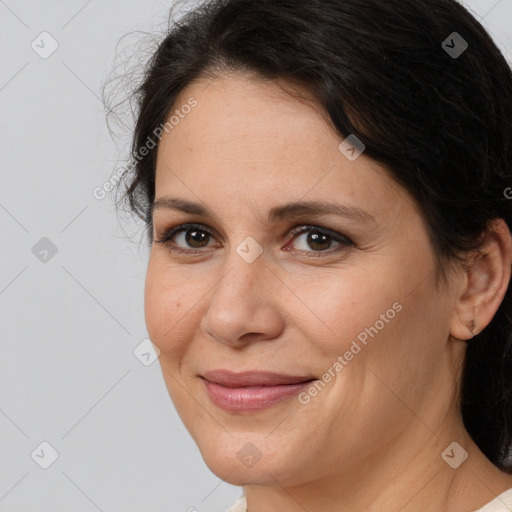 Joyful white adult female with medium  brown hair and brown eyes