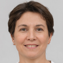 Joyful white adult female with short  brown hair and brown eyes