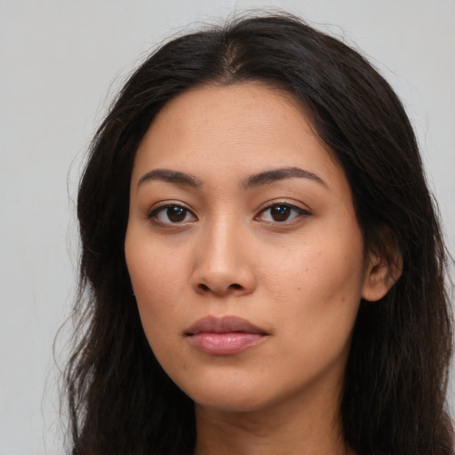 Neutral latino young-adult female with long  brown hair and brown eyes