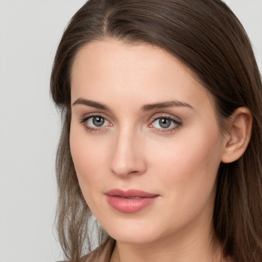 Joyful white young-adult female with long  brown hair and grey eyes