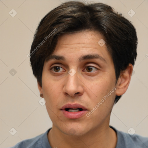 Joyful white adult male with short  brown hair and brown eyes