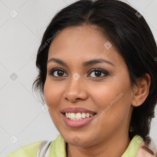 Joyful latino young-adult female with medium  brown hair and brown eyes