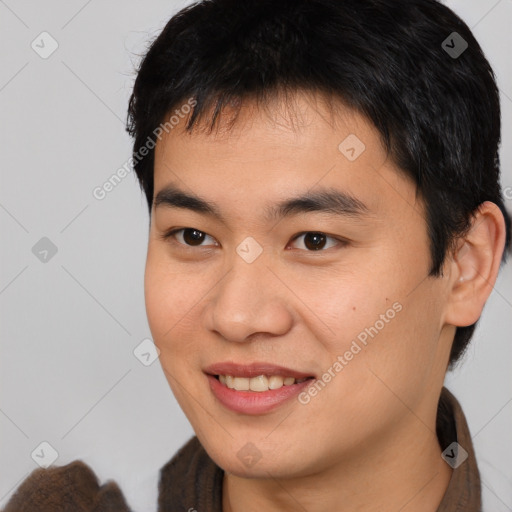 Joyful asian young-adult male with short  brown hair and brown eyes