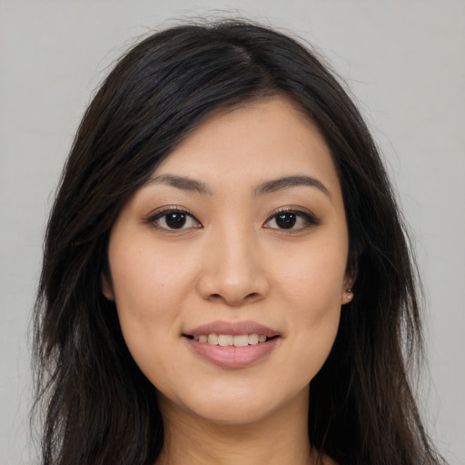 Joyful asian young-adult female with long  black hair and brown eyes