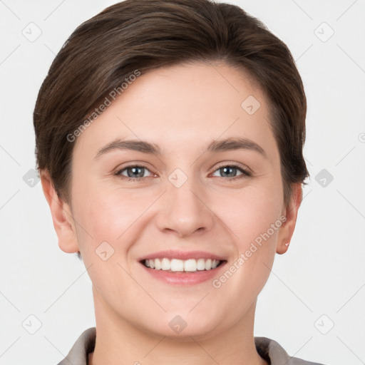 Joyful white young-adult female with short  brown hair and grey eyes