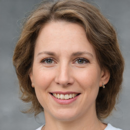 Joyful white adult female with medium  brown hair and brown eyes