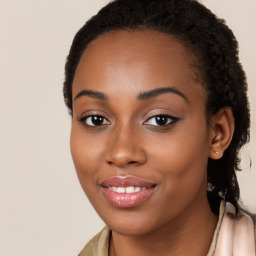 Joyful black young-adult female with long  brown hair and brown eyes