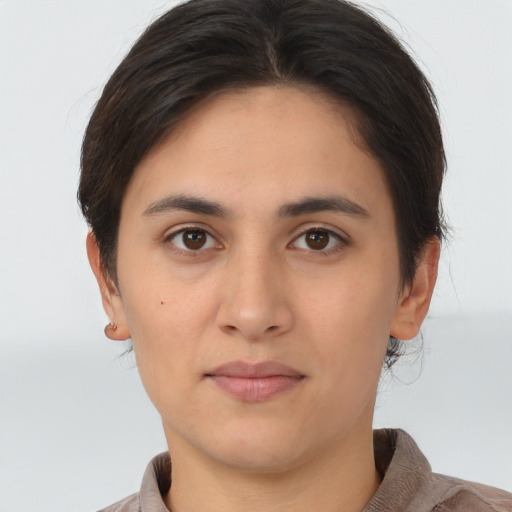 Joyful asian young-adult female with short  brown hair and brown eyes