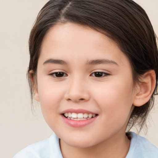 Joyful white child female with medium  brown hair and brown eyes