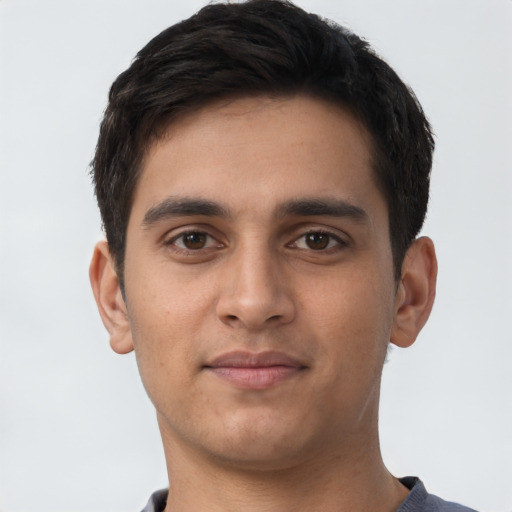 Joyful latino young-adult male with short  brown hair and brown eyes