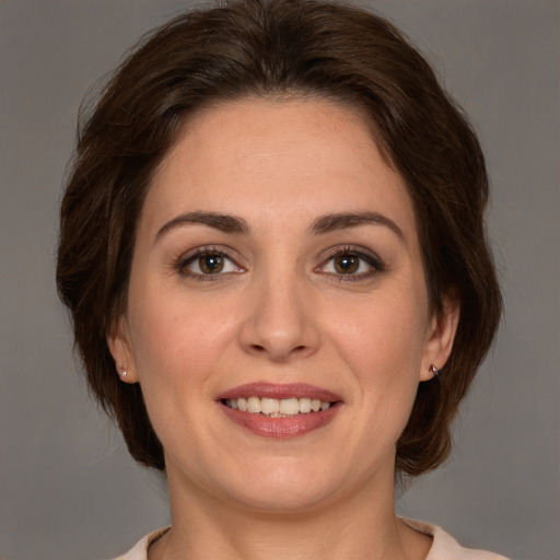 Joyful white young-adult female with medium  brown hair and brown eyes