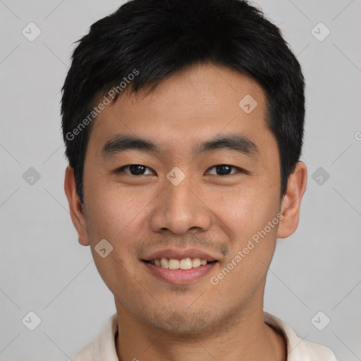 Joyful asian young-adult male with short  black hair and brown eyes