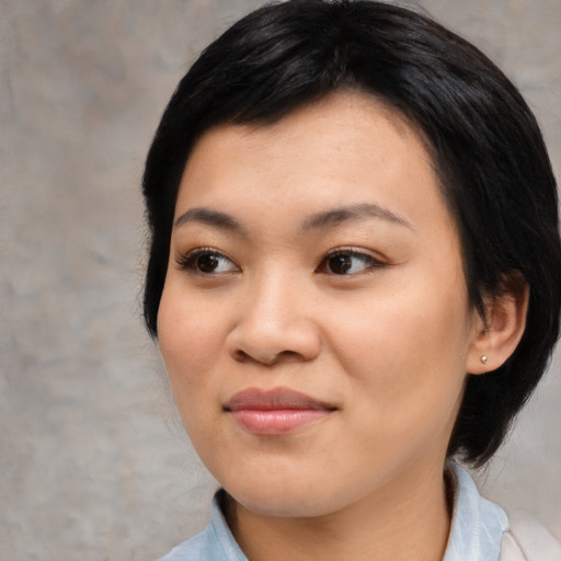 Joyful asian young-adult female with medium  black hair and brown eyes