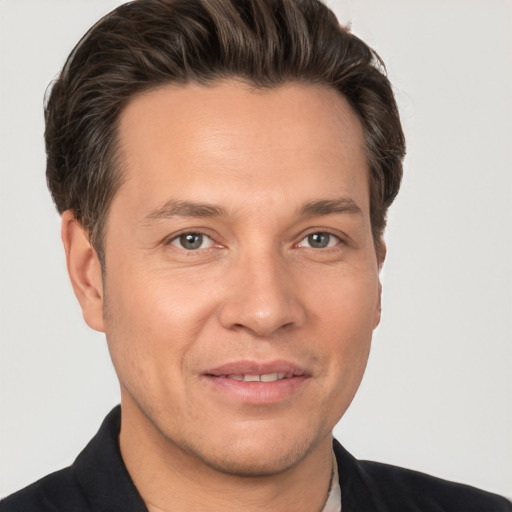 Joyful white adult male with short  brown hair and brown eyes