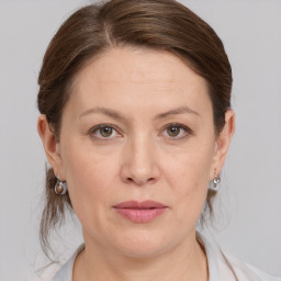 Joyful white adult female with medium  brown hair and grey eyes