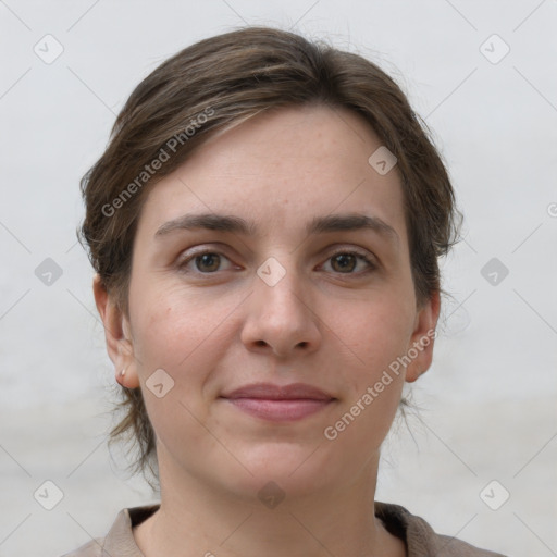 Joyful white young-adult female with short  brown hair and grey eyes