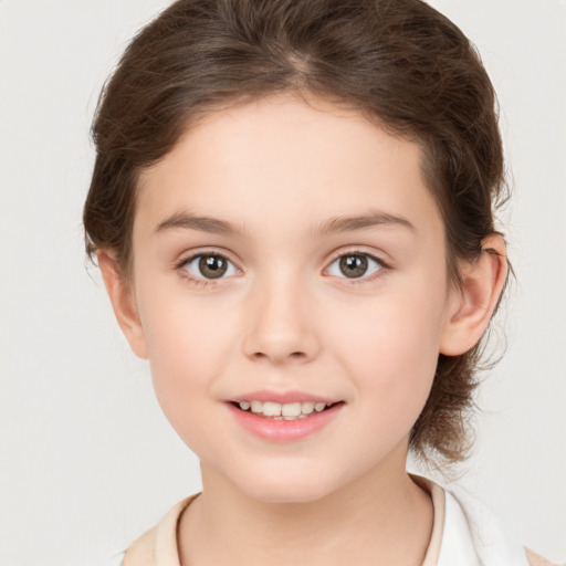 Joyful white child female with medium  brown hair and brown eyes