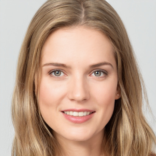 Joyful white young-adult female with long  brown hair and grey eyes