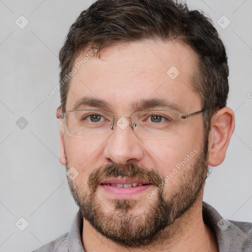 Joyful white adult male with short  brown hair and brown eyes