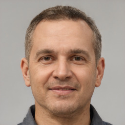 Joyful white adult male with short  brown hair and brown eyes