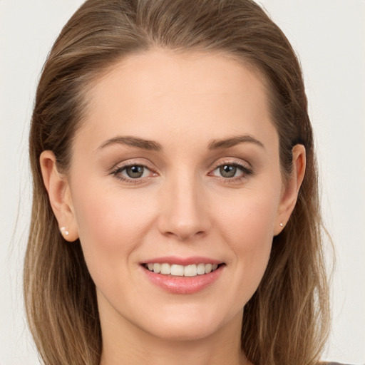 Joyful white young-adult female with long  brown hair and grey eyes