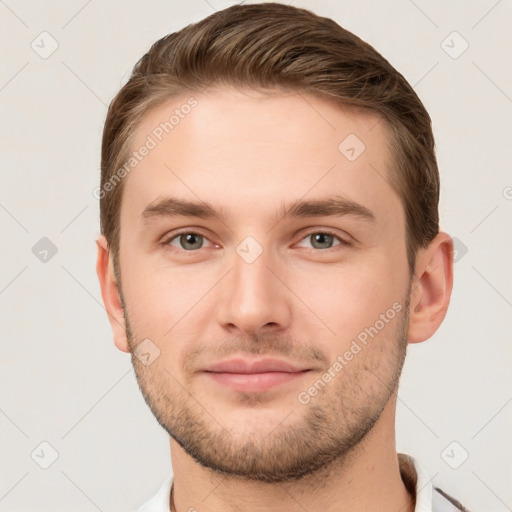 Joyful white young-adult male with short  brown hair and grey eyes