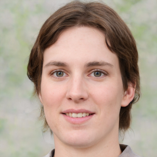 Joyful white young-adult female with medium  brown hair and green eyes