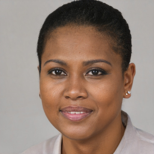 Joyful black young-adult female with short  brown hair and brown eyes