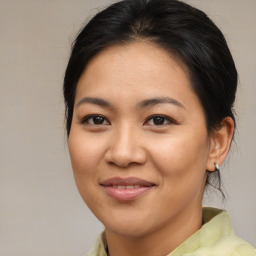 Joyful asian young-adult female with medium  brown hair and brown eyes