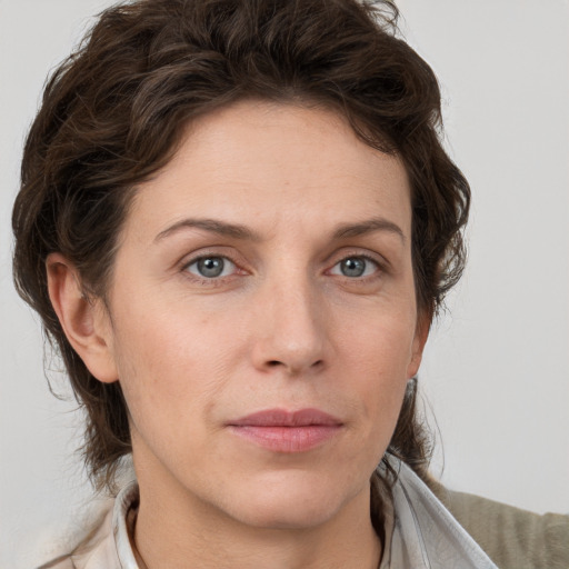 Joyful white adult female with short  brown hair and grey eyes