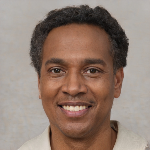 Joyful latino adult male with short  black hair and brown eyes