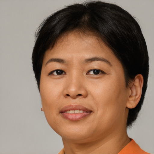 Joyful asian adult female with short  brown hair and brown eyes