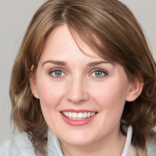 Joyful white young-adult female with medium  brown hair and blue eyes