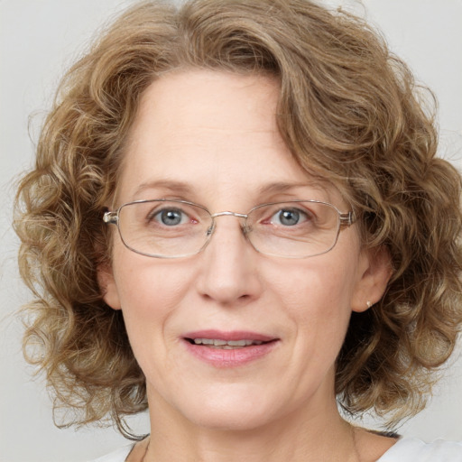 Joyful white adult female with medium  brown hair and blue eyes