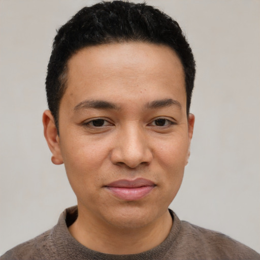 Joyful latino young-adult male with short  black hair and brown eyes