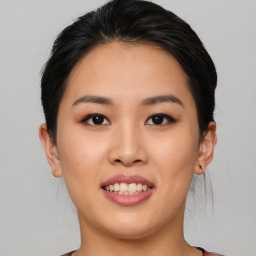 Joyful asian young-adult female with short  black hair and brown eyes