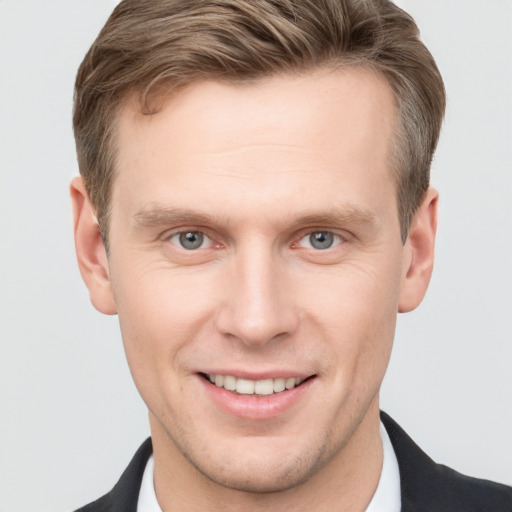 Joyful white adult male with short  brown hair and grey eyes