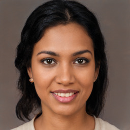 Joyful latino young-adult female with medium  black hair and brown eyes