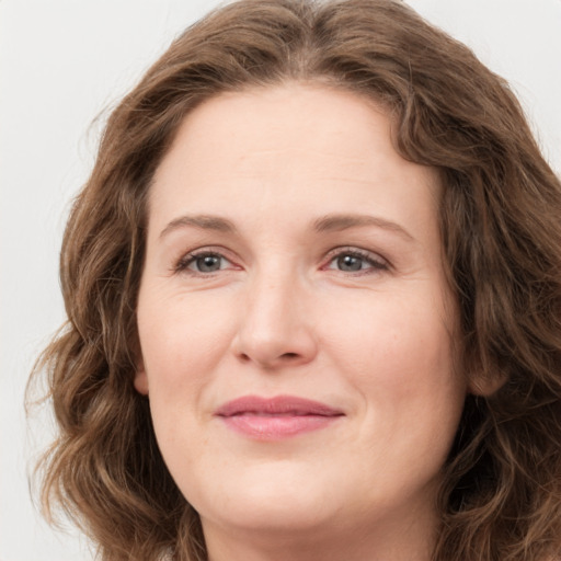 Joyful white young-adult female with long  brown hair and green eyes