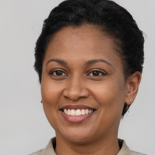 Joyful latino adult female with short  brown hair and brown eyes
