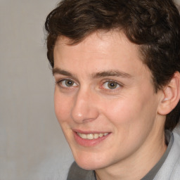 Joyful white young-adult male with medium  brown hair and brown eyes