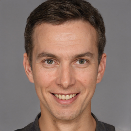 Joyful white adult male with short  brown hair and brown eyes