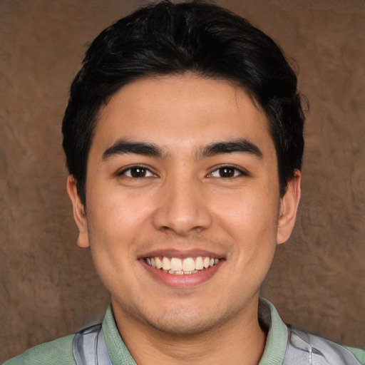 Joyful white young-adult male with short  black hair and brown eyes