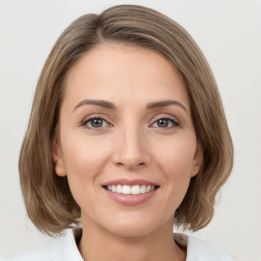 Joyful white young-adult female with medium  brown hair and brown eyes