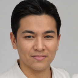 Joyful asian young-adult male with short  brown hair and brown eyes