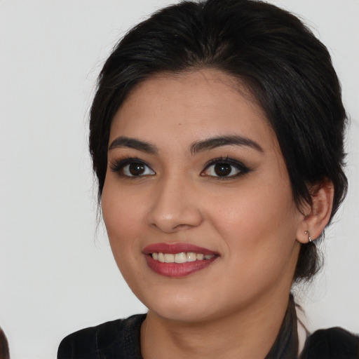 Joyful asian young-adult female with medium  black hair and brown eyes