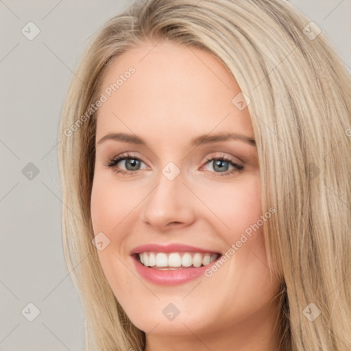 Joyful white young-adult female with long  brown hair and blue eyes