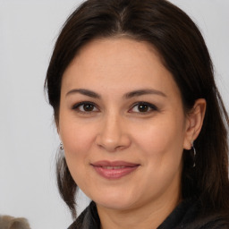 Joyful white adult female with medium  brown hair and brown eyes