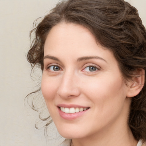 Joyful white young-adult female with medium  brown hair and green eyes